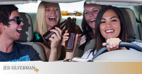 People drinking inside a car